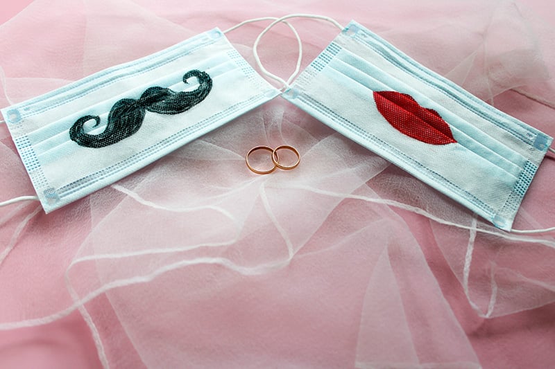 Two medical masks with a mustache and lips design. A symbol of love during the pandemic.