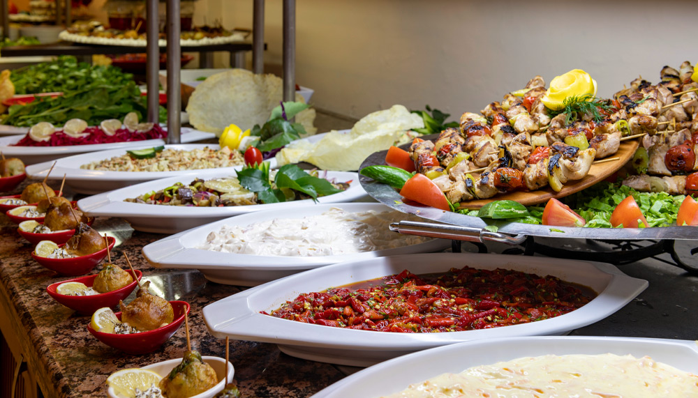 A spread of various food items on plates. Different cuisines are displayed.
