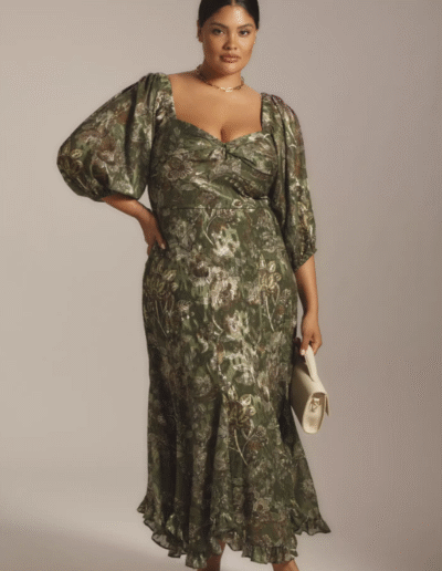 A woman wearing a long dress. She is posing.