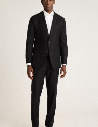 Man wearing a suit. He is standing still.