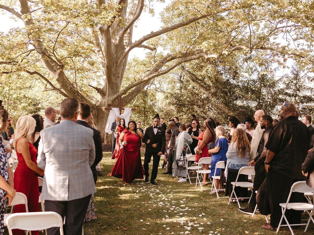 Guests dressed in formal attire waiting for outdoor wedding ceremony