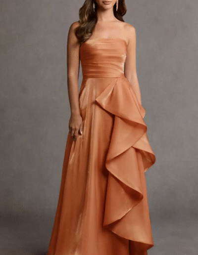 A woman wearing a long dress. She is standing outside.