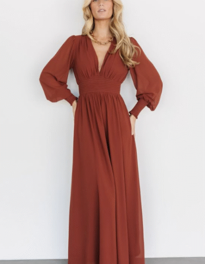 A woman wearing a long dress. The image is grainy.